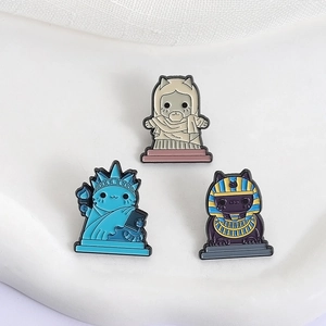 Cartoon enamel cat pins featuring mummy, pharaoh, and Statue of Liberty cat designs