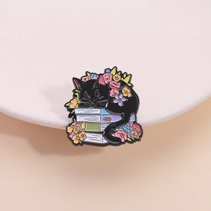 Cartoon black cat sleeping on colorful books with flowers metal enamel brooch pin
