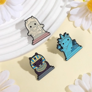 Enamel cat brooches set featuring Statue of Liberty and Egyptian pharaoh cat designs