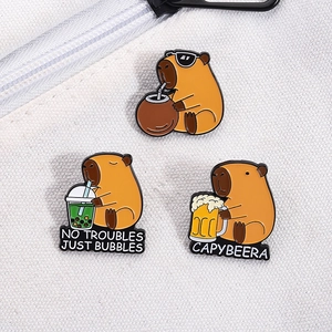 Three-piece capybara enamel pin set featuring fun drink themes on white canvas