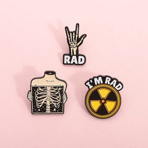 Three-piece punk enamel pin set featuring skeletal hands, X-ray ribcage and radiation sign