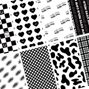 Detailed view of DIY phone stickers featuring black and white milk cow and heart patterns