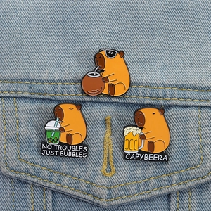 Cute capybara enamel pin set with coconut and beer motifs on denim jacket pocket