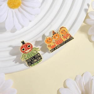 Halloween enamel pin set featuring pumpkin heads and ghosts on a white display stand