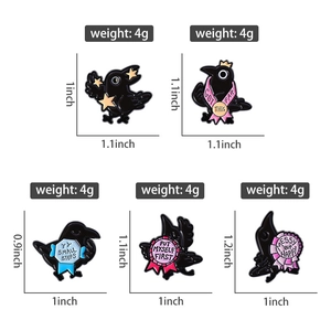 Detail view of raven enamel pins showing 0.9-1.2 inch sizes and inspirational text