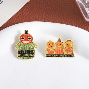 Halloween enamel pins featuring pumpkin scarecrow and festive slogans on a ceramic plate