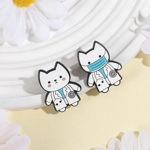 Cute white cat doctor enamel pins with stethoscope detail on a minimal white podium