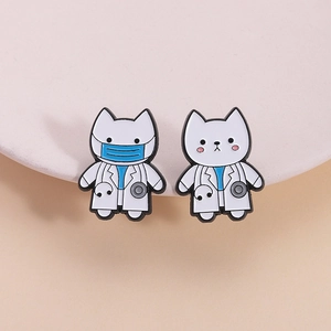 Set of two cute white cat doctor enamel pins featuring blue masks and gray stethoscopes