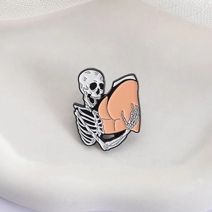 Funny skeleton hugging a peach butt enamel pin in punk style on a beige background