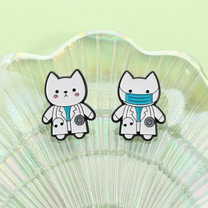 Cute cartoon cat doctor enamel pins with stethoscope and medical mask on glass tray