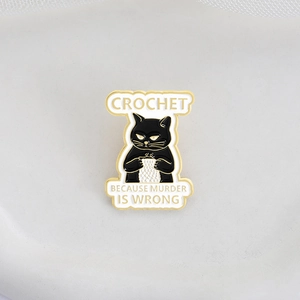 Funny black cat crochet enamel pin with 'Crochet Because Murder Is Wrong' slogan