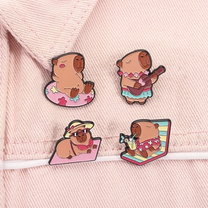Detail view of four cute enamel capybara badges on pink denim collar for accessories