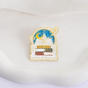 Enamel book brooch featuring mountains and dragons with High Lords and Wing Leaders text