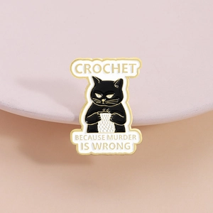 Black cat crochet enamel pin with Crochet Because Murder Is Wrong slogan badge