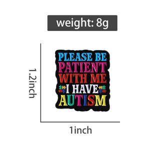 Detail of autism awareness enamel pin with colorful puzzle and please be patient text