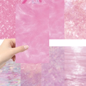 Close-up of pink glitter decorative paper sheets for DIY scrapbooking and crafts