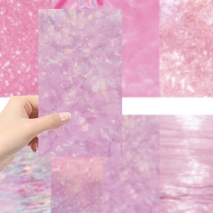 Detail of pink and purple holographic sticker with ice texture and glitter finish
