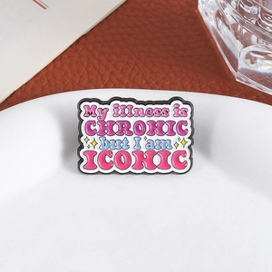 Enamel pin featuring My illness is CHRONIC but I am ICONIC text with pink accents