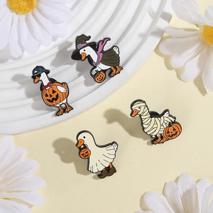 Macro detail of four Halloween enamel pins featuring geese in spooky festive costumes