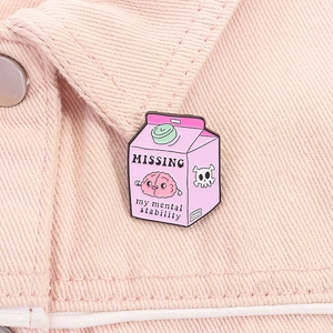 Close-up of pink milk carton enamel pin on denim jacket collar featuring mental health theme
