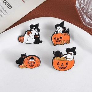 Set of four Halloween enamel pins featuring black cat and ghost on a white ceramic plate