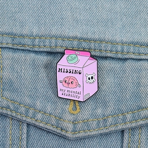 Funny pink brain missing mental stability enamel pin badge on blue denim jacket