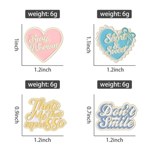 Detail view of heart and text enamel pins with precise dimensions and weight specs