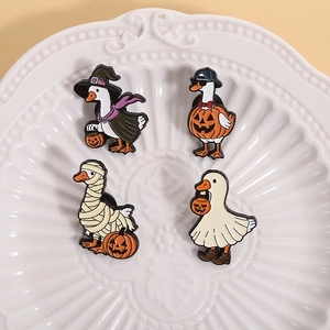Set of four cute Halloween duck enamel pins featuring witch, pumpkin, and ghost designs