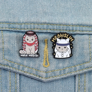 Creative enamel cat brooches with traditional headscarves on a denim jacket pocket