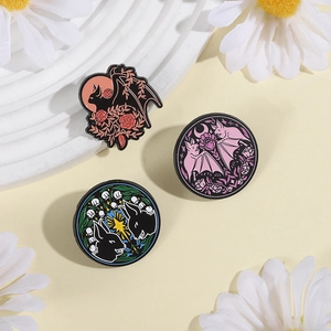 Dark gothic enamel pin set featuring bats, roses, and crescent moons on a display stand
