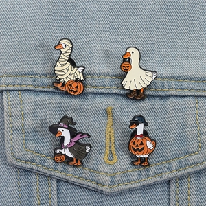 Funny Halloween goose enamel pins set on denim jacket featuring mummy and ghost designs