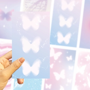 Close-up of DIY phone case card with dreamy purple gradient and white butterflies