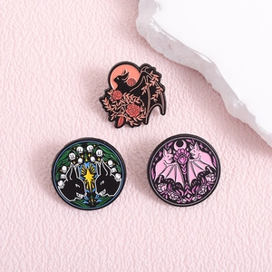 Dark fantasy enamel pin set featuring bat, skull, and animal patterns on a pink surface