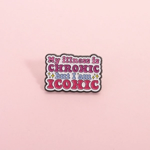 Cartoon enamel pin with 'My illness is CHRONIC but I am ICONIC' quote and star design