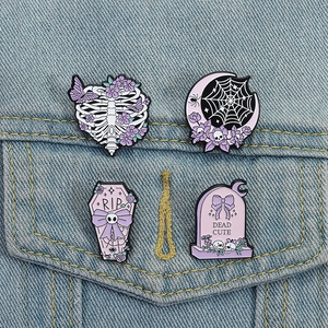 Gothic Halloween enamel pins set on denim jacket featuring skull and coffin designs