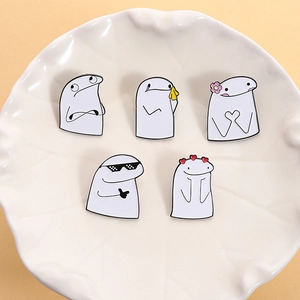 Five-piece cartoon Flork enamel pin set with funny expressions in a white ceramic dish