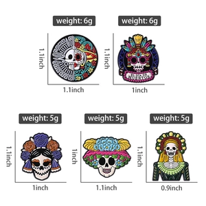 Detailed view of Mexican Day of the Dead skull enamel pins with weights and sizes