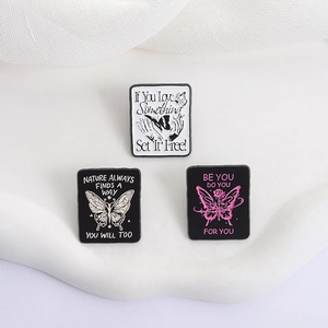 Set of three creative butterfly enamel pins with inspirational quotes on black metal base