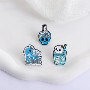 Three-piece skull hydration enamel pin set in light blue and white on a wavy display