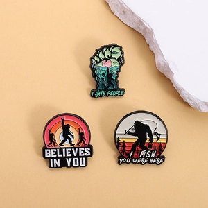 Three-piece Bigfoot enamel pin set featuring outdoor fishing and forest theme designs