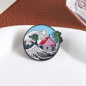 Geometric round enamel pin featuring ocean waves and tropical palm tree house design
