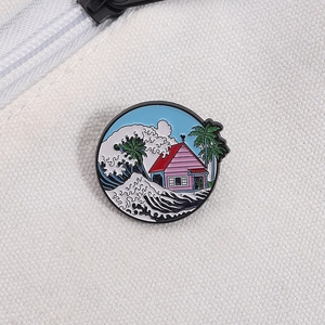 Detailed macro shot of a round enamel pin featuring a pink beach house and ocean wave