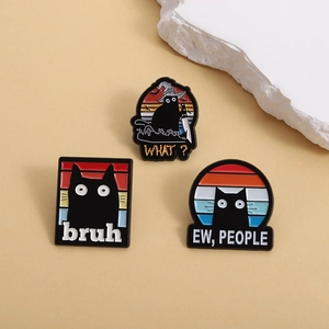 Three cute black cat enamel pins featuring funny slogans and spooky Halloween witch hats