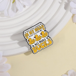 Funny little yellow duck enamel pin with 'Get More Ducks' humorous slogan badge