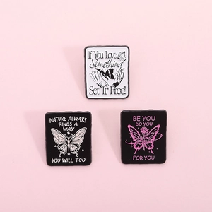 Motivational butterfly enamel pin set with inspirational quotes on soft pink background