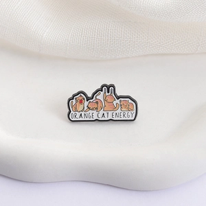 Whimsical orange cat enamel pin set featuring funny poses and orange cat energy text