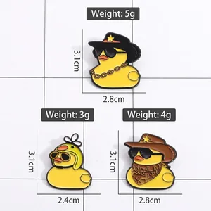 Three cute yellow duck enamel pins with sunglasses and helmets showing dimensions