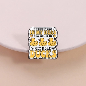 Funny little yellow duck enamel pin with creative text on a minimalist display stand