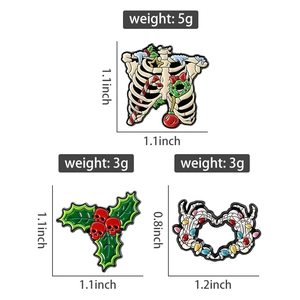 Macro view of gothic Christmas pins set with skull leaves and bone heart badge dimensions