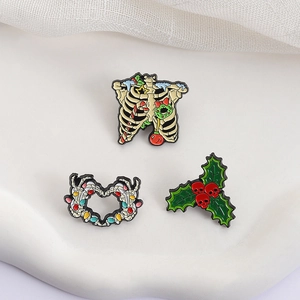 Gothic Halloween Christmas enamel pin set featuring skeleton holly and festive skull motifs